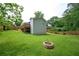 Spacious backyard with lush green grass, privacy fence, and a fire pit for outdoor enjoyment at 963 Turner Se Dr, Smyrna, GA 30080