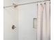 Clean bathroom featuring modern herringbone tiling, updated fixtures, and shower with curtain at 963 Turner Se Dr, Smyrna, GA 30080