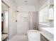 Bathroom featuring a standalone tub, a shower with gray tile, and white cabinets at 963 Turner Se Dr, Smyrna, GA 30080