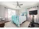 Bedroom featuring a blue bed frame, white linens, patterned rug, desk, and workout bike at 963 Turner Se Dr, Smyrna, GA 30080