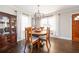 Bright dining room with hardwood floors, modern chandelier, and wood dining table at 963 Turner Se Dr, Smyrna, GA 30080
