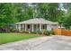 Charming single-story home featuring a well-manicured lawn and inviting front porch with a cheerful blue door at 963 Turner Se Dr, Smyrna, GA 30080