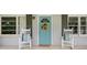 Inviting front porch with rocking chairs and a blue door, perfect for enjoying quiet moments outdoors at 963 Turner Se Dr, Smyrna, GA 30080