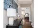 Hallway with dark floors with lamp, artwork and table. Doorway leads to primary bedroom at 963 Turner Se Dr, Smyrna, GA 30080