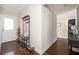 Hallway with coat rack, plant, and dark hardwood floors with doorway to laundry room in background at 963 Turner Se Dr, Smyrna, GA 30080