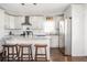 Well-lit kitchen with stainless steel appliances, island with seating and tile backsplash at 963 Turner Se Dr, Smyrna, GA 30080
