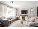 Cozy living room with a plush sectional sofa, stylish decor, and a modern entertainment center at 963 Turner Se Dr, Smyrna, GA 30080