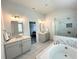 Spacious bathroom showcasing double vanities, a soaking tub, and a glass-enclosed shower at 306 Coppergate Ct, Canton, GA 30115