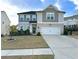 Charming two-story home with well-manicured lawn and a two-car garage, perfect for suburban living at 306 Coppergate Ct, Canton, GA 30115