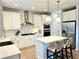 Modern kitchen featuring white cabinets, stainless steel appliances, and an island with seating at 306 Coppergate Ct, Canton, GA 30115