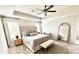 Serene main bedroom with a tray ceiling, tufted headboard, and a cozy seating area at 306 Coppergate Ct, Canton, GA 30115