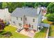 An aerial view of the house showcasing the backyard with a patio and green grass at 560 Edgehill Pl, Johns Creek, GA 30022