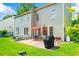 Well-maintained backyard with patio, seating, grill, and lush green lawn at 560 Edgehill Pl, Johns Creek, GA 30022