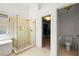 Modern bathroom featuring a walk-in shower with glass doors, a separate toilet room, and tiled floors at 560 Edgehill Pl, Johns Creek, GA 30022
