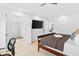 Spacious bedroom with a view to the bathroom, a large television, and neutral-toned walls and carpets at 560 Edgehill Pl, Johns Creek, GA 30022