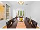 Spacious dining room with a large table, hardwood floors, and arched doorway at 560 Edgehill Pl, Johns Creek, GA 30022
