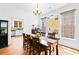 Charming dining room with wooden table set, chandelier lighting, and view into the kitchen at 560 Edgehill Pl, Johns Creek, GA 30022