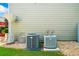 Home's exterior showing AC units and gravel landscaping at 560 Edgehill Pl, Johns Creek, GA 30022