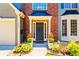 Close-up of the front door entrance, adorned with potted plants and a walkway leading to the welcoming entryway at 560 Edgehill Pl, Johns Creek, GA 30022