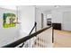 Bright hallway featuring white walls and trim, carpet, chandelier, staircase, and a view from the arched window at 560 Edgehill Pl, Johns Creek, GA 30022