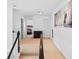 Upstairs hallway with artwork and views into bedrooms, featuring neutral carpet at 560 Edgehill Pl, Johns Creek, GA 30022