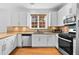 Bright kitchen with white cabinets, granite countertops, stainless steel appliances and backsplash at 560 Edgehill Pl, Johns Creek, GA 30022
