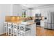 Contemporary kitchen with granite countertops, white cabinets, stainless appliances, and breakfast bar seating at 560 Edgehill Pl, Johns Creek, GA 30022