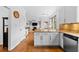 Bright and open kitchen with white cabinets, stainless steel appliances, and views to the living room at 560 Edgehill Pl, Johns Creek, GA 30022