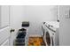 Well-organized laundry room featuring a washer, dryer, and shelving units at 560 Edgehill Pl, Johns Creek, GA 30022