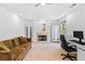 Inviting living room with a cozy fireplace, tray ceilings, and comfortable seating at 560 Edgehill Pl, Johns Creek, GA 30022