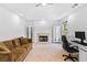 Living room featuring a fireplace, plush couch, tray ceiling, and white built-in cabinets with glass doors at 560 Edgehill Pl, Johns Creek, GA 30022