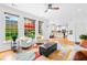 Bright, open-concept living room with hardwood floors and view of landscaped backyard at 560 Edgehill Pl, Johns Creek, GA 30022