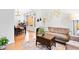 Bright living room with hardwood floors, neutral furniture, large windows, and an arched entrance at 560 Edgehill Pl, Johns Creek, GA 30022