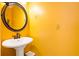 Charming powder room featuring a pedestal sink and a decorative mirror at 560 Edgehill Pl, Johns Creek, GA 30022