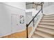 Elegant staircase with carpeted steps and a contrasting black handrail at 560 Edgehill Pl, Johns Creek, GA 30022