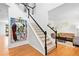 Open staircase and foyer with beautiful artwork, leading into the living room at 560 Edgehill Pl, Johns Creek, GA 30022