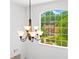 Arched window with view of green trees and blue skies that brighten up the room, with a chandelier hanging down at 560 Edgehill Pl, Johns Creek, GA 30022