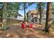 Cozy backyard firepit area featuring chairs, a wooden privacy fence and mature trees offering shade at 5735 Lake Windsor Pkwy, Buford, GA 30518