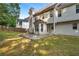 Backyard patio, with a view of the home's exterior, showcasing a well-maintained lawn and privacy fence at 5735 Lake Windsor Pkwy, Buford, GA 30518