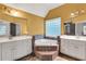 Luxurious bathroom with a corner tub, double vanity, and tile flooring at 5735 Lake Windsor Pkwy, Buford, GA 30518