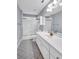 Clean bathroom featuring a vanity, sink, toilet, tub, and a glass-enclosed shower at 5735 Lake Windsor Pkwy, Buford, GA 30518