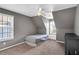 Attic bedroom with angled ceilings, a bed, a dresser, and a bright window seat at 5735 Lake Windsor Pkwy, Buford, GA 30518