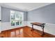 Sunny dining room with hardwood floors, wainscoting, and large window at 5735 Lake Windsor Pkwy, Buford, GA 30518