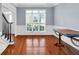 Formal dining room with hardwood floors, wainscoting, and large windows at 5735 Lake Windsor Pkwy, Buford, GA 30518