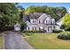 Beautiful brick home featuring a long driveway, attached garage, and a beautifully landscaped front yard at 5735 Lake Windsor Pkwy, Buford, GA 30518