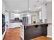 Kitchen with stainless steel refrigerator, modern appliances, white cabinets, and wooden breakfast bar at 5735 Lake Windsor Pkwy, Buford, GA 30518