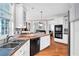 Kitchen features stainless steel sink, dishwasher, and appliances, along with white cabinets and wood floors at 5735 Lake Windsor Pkwy, Buford, GA 30518