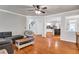 Open-concept living room with hardwood floors, staircase, and connecting kitchen at 5735 Lake Windsor Pkwy, Buford, GA 30518