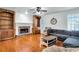 Cozy living room features a stone fireplace, custom built-ins, and ample natural light at 5735 Lake Windsor Pkwy, Buford, GA 30518