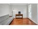 Bright living room with hardwood floors, a gray sofa, and a charming wooden table at 5735 Lake Windsor Pkwy, Buford, GA 30518